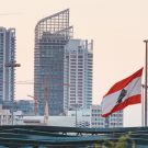Building construction and Lebanese flag at half mast in Beirut, Lebanon