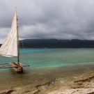 Sail boat on the water with clouds in the sky